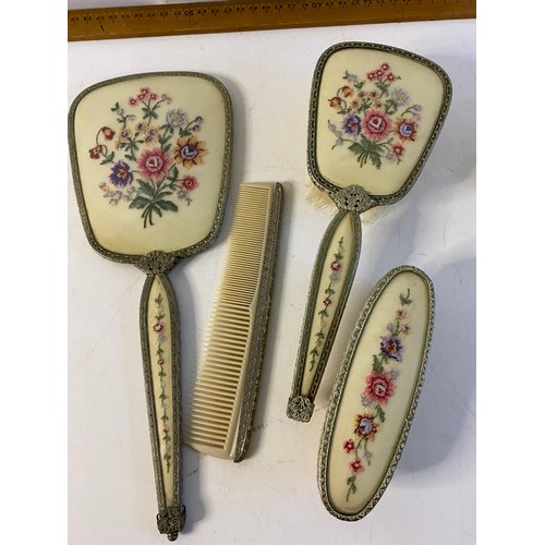 814 - Vintage dressing table set comprising hair brush, clothes brush, comb and a mirror, handle needs rep... 