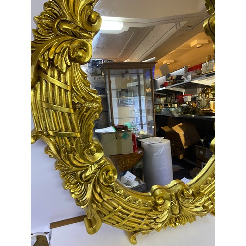 838 - Ornate gold framed mirror measuring 110 x 86 cms