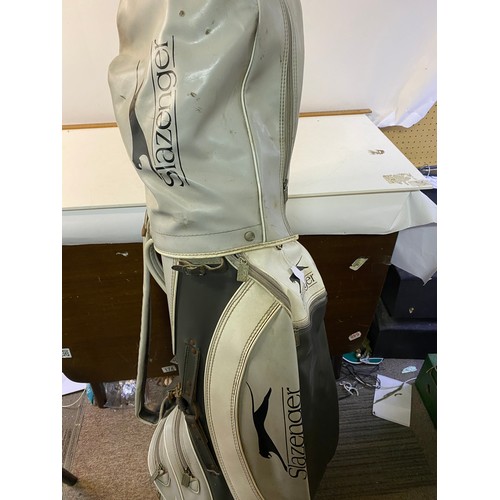 664 - Slazenger golf bag with an assortment of clubs.