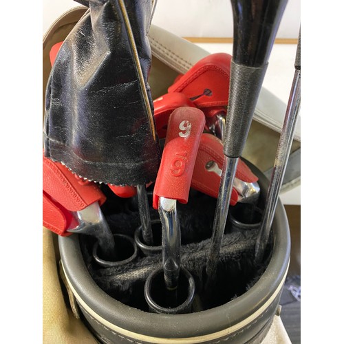 664 - Slazenger golf bag with an assortment of clubs.