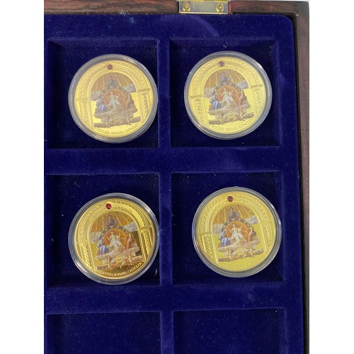 1007 - Selection of 10 Religous gold tone commemorative coins with colour pictures in display case.