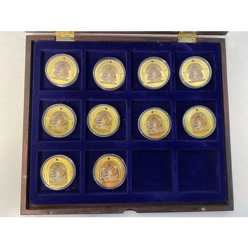 1007 - Selection of 10 Religous gold tone commemorative coins with colour pictures in display case.