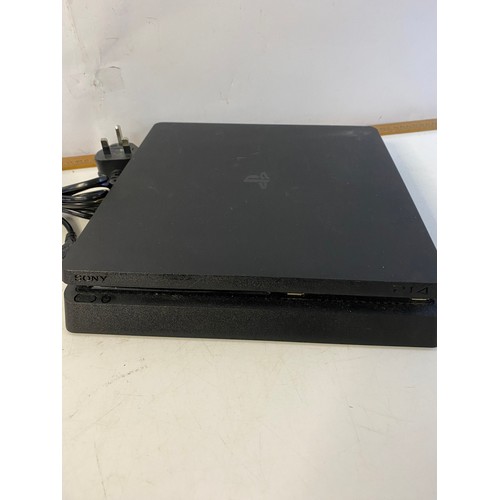 145 - Playstation 4 slim console 1TB with controller and games. Tested and working.