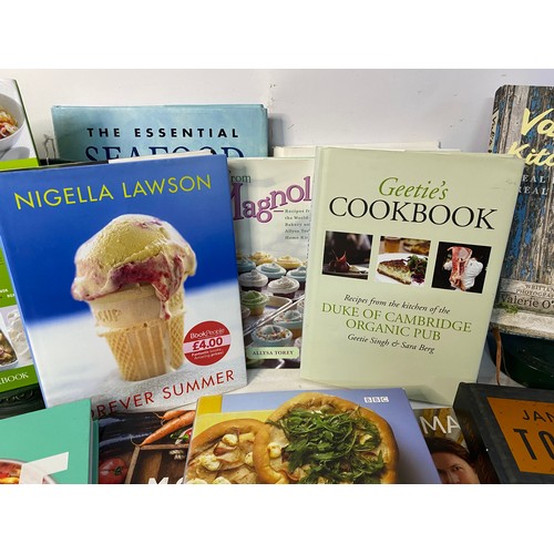 196 - 2 vintage cast iron cookery book stands plus a selection of cookery books.