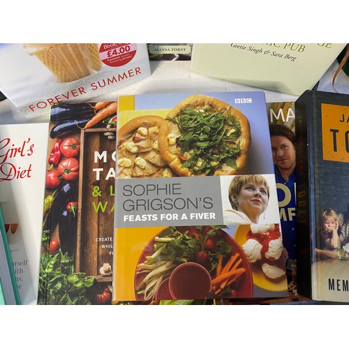 196 - 2 vintage cast iron cookery book stands plus a selection of cookery books.