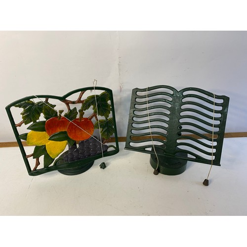 196 - 2 vintage cast iron cookery book stands plus a selection of cookery books.