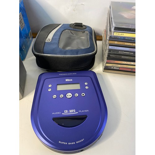 240 - Mbox portable CD player with mini stereo speakers and a selection of CDs, in working order.