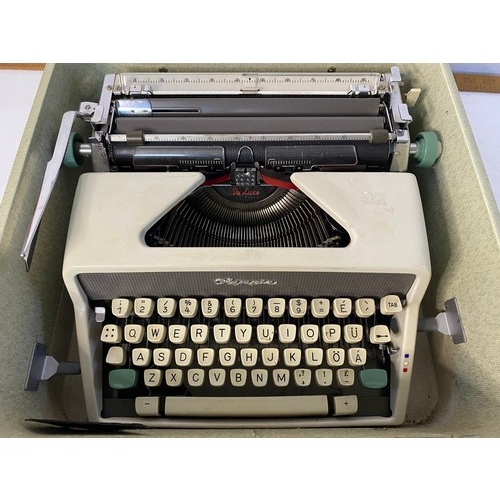 216 - Vintage Olympia Deluxe portable typewriter in carry case.