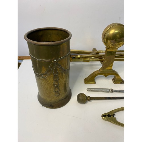 634 - Selection of brass fireside tools and fire dogs.