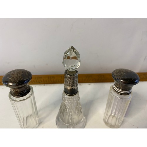 644 - 3 Hallmarked silver scent bottles dated 1923 and 1926 both with stoppers. Largest is 10.5cms tall