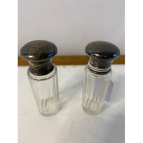 644 - 3 Hallmarked silver scent bottles dated 1923 and 1926 both with stoppers. Largest is 10.5cms tall