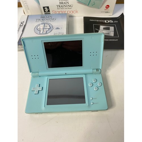 661 - Mint green Nintendo DS lite with games. No charger but in working order.