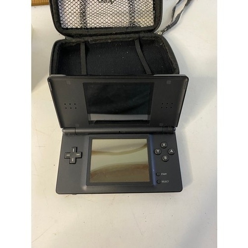 662 - Black Nintendo DS lite with games. No charger but in working order.