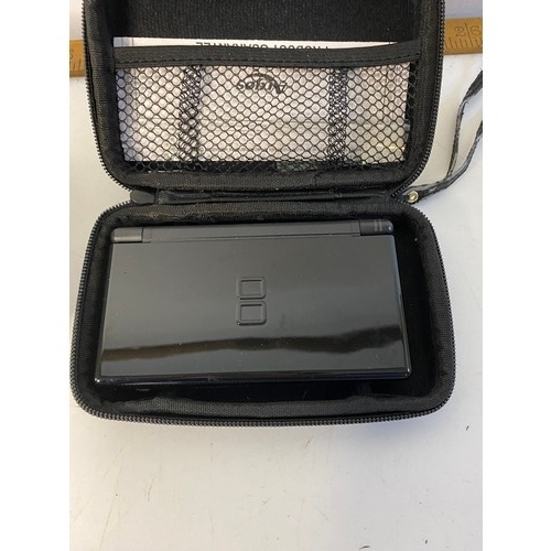 662 - Black Nintendo DS lite with games. No charger but in working order.