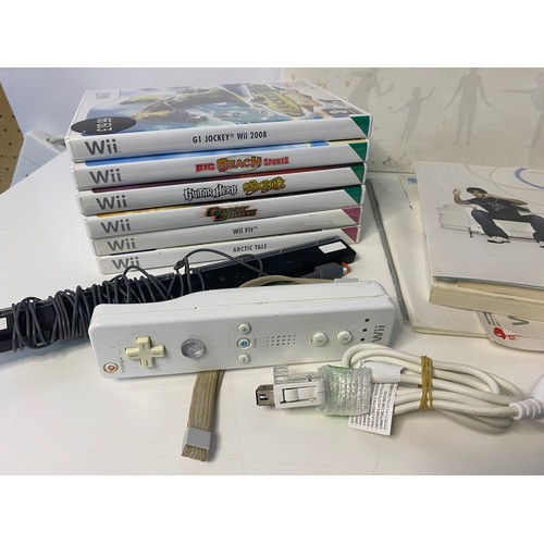 606 - Nintendo Wii console with games and accessories including fitboard.