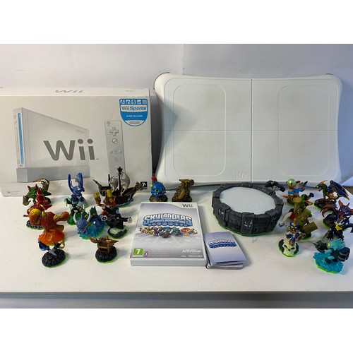 744 - Boxed Nintendo Wii with games and accessories including fit board, Skylanders bundle and more, in wo... 