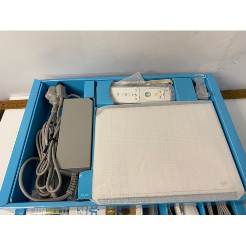 744 - Boxed Nintendo Wii with games and accessories including fit board, Skylanders bundle and more, in wo... 