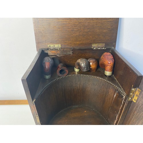 641 - 1920's Oak Smokers cabinet with bevelled glass window with a selection of pipes. 31x25.5cms