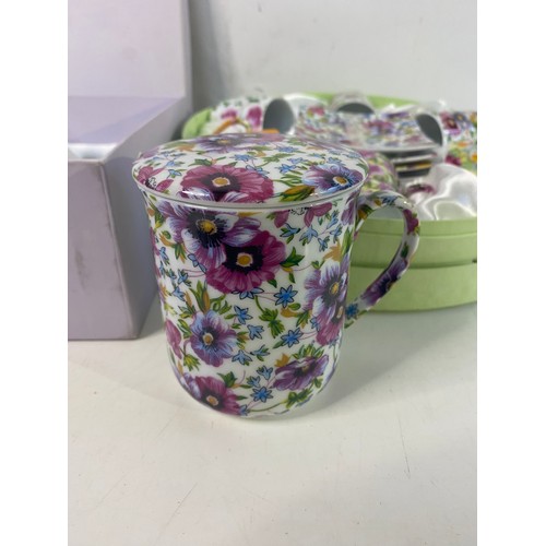 A boxed tea cup set (missing a cup) and coffee cup set