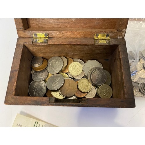 Wooden money box with selection of old coins and notes