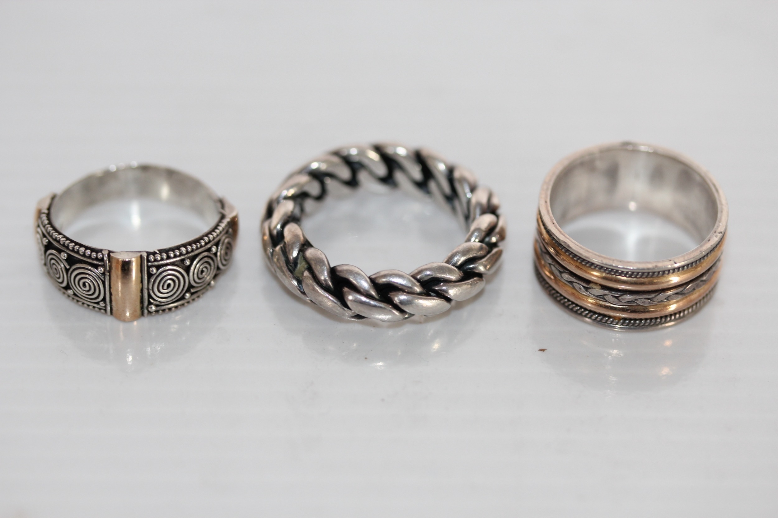Three silver 'Suarti' rings including a chunky wedding band, 18g.