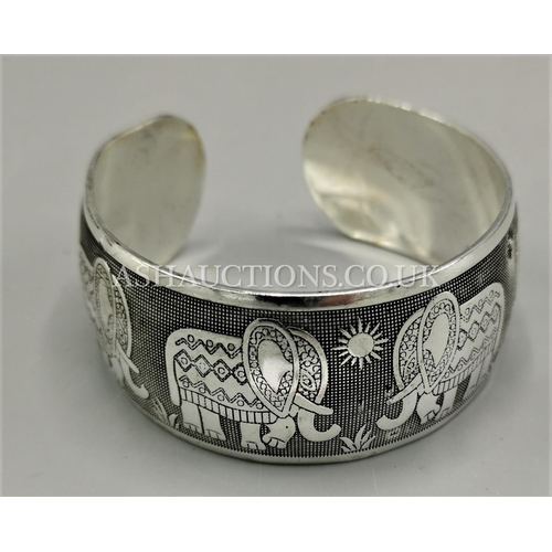 586 - PRESENTED AS A TIBETAN SILVER ELEPHANT DESIGN BANGLE