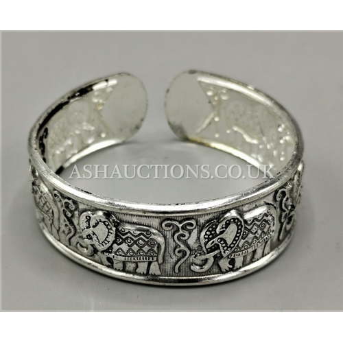 587 - PRESENTED AS A TIBETAN SILVER ELEPHANT DESIGN CUFF BRACELET