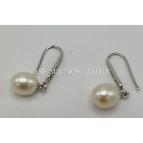 334 - PRESENTED AS A PAIR OF SILVER & PEARL EARRINGS