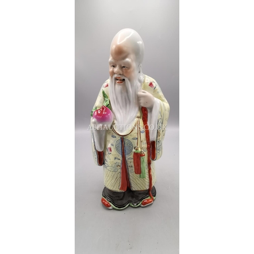 78 - POTTERY FIGURINE OF A CHINESE ELDAR WITH FRUIT (Mid 20th Century)