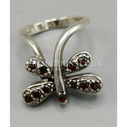 897 - PRESENTED AS A SILVER BUTTERFLY RING WITH GARNETS. (Stamped 925.)(Weight 8.7 Grams) (Size R)