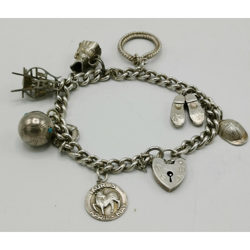 1198 - PRESENTED AS A SILVER CHARM BRACELET (Stamped 925) WITH PADLOCK,SAFETY CHAIN Plus EIGHT CHARMS  (Wei... 