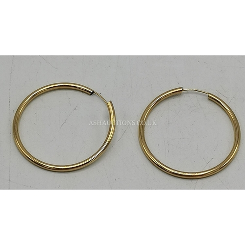 1209 - PRESENTED AS A PAIR OF 9ct GOLD (Stamped 9ct) Large HOOP EARRINGS (Weight 1.5 Grams)