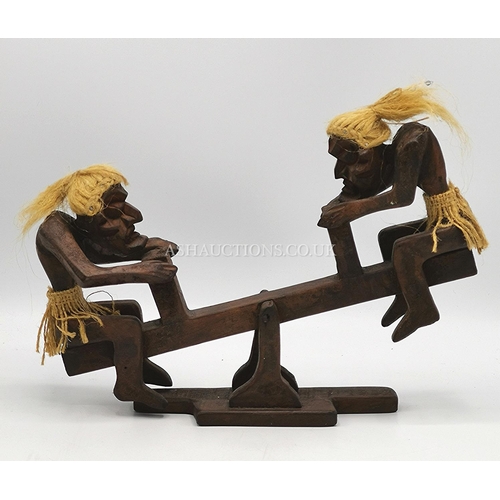 582 - AFRICAN TRIBAL ART MODEL OF TWO FIGURINES ON A SEE SAW