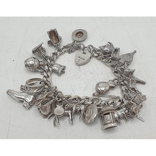 653 - PRESENTED AS A SILVER (Hallmarked For 1978) CHARM BRACELET (Probably By Robert Pringle) With OVER 20... 