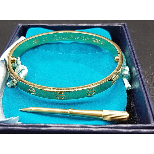 106 - PRESENTED AS AS A YELLOW METAL CARTIER  BANGLE  (Boxed)