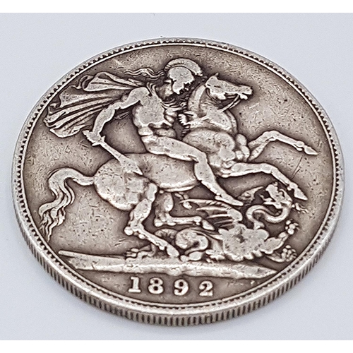 679 - PRESENTED AS A SILVER VICTORIAN CROWN (Dated 1892)