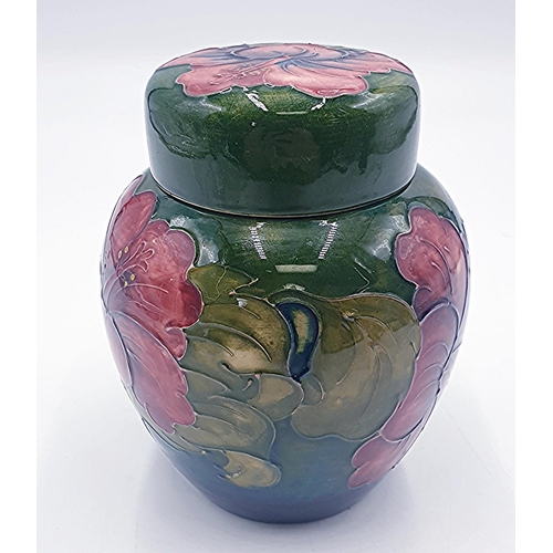 771 - MOORCROFT 14cm GINGER JAR IN THE HIBICUS DESIGN ON GREEN GROUND