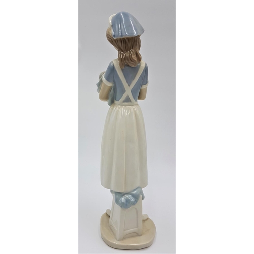 717 - LLADRO (Nao) PORCELAIN Extra Large 33cm x 9cm x 11cm CHARACTER FIGURINE OF A YOUNG NURSE HOLDING A N... 