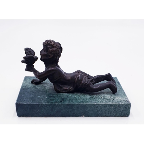 121 - SOLID BRONZE 13 cm x 8 cm (Early 20th Century) FIGURINE OF A RECUMBENT BOY HOLDING A BIRD MOUNTED ON... 