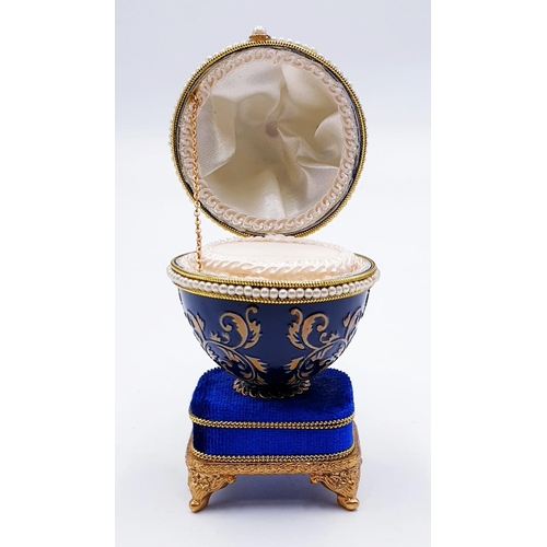 752 - ENAMEL EGG SHAPED MUSICAL RING BOX