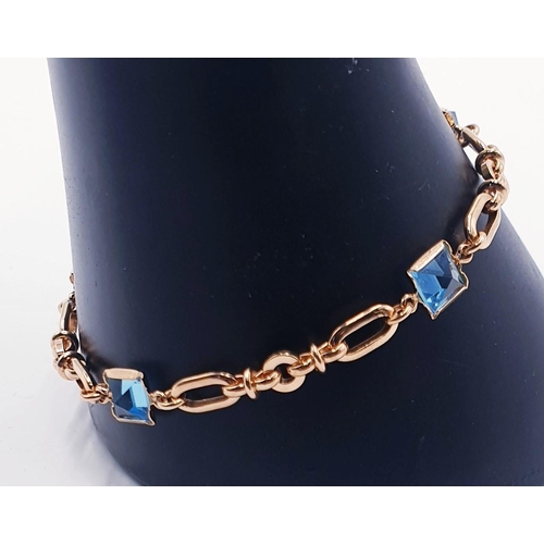 741 - YELLOW METAL / BLUE TOPAZ STONE SET BRACELET