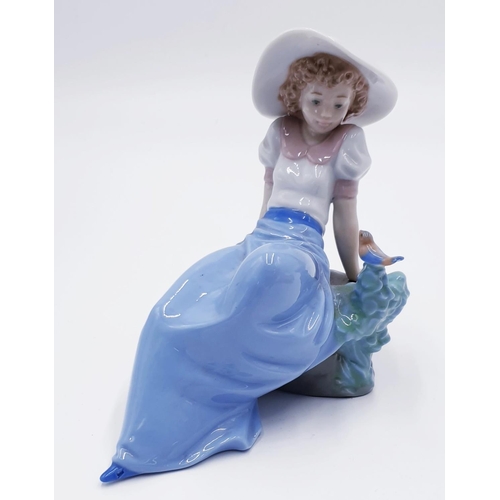 758A - LLADRO (Nao) PORCELAIN Large 15cm x 15cm CHARACTER OF A YOUNG GIRL LEANING AGAINST ROCKS With BIRD 