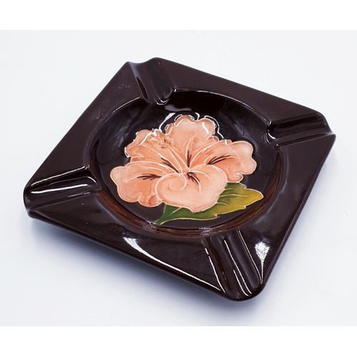 872 - MOORCROFT SQUARE ASHTRAY IN THE HIBISCUS DESIGN ON BROWN GROUND