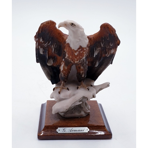 721 - CAPODIMONTE MODEL OF AN EAGLE MOUNTED ON A WOODEN PLINTH Signed