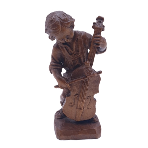 179 - SWISS 10cm WOODEN CARVING OF A BOY PLAYING A CELLO