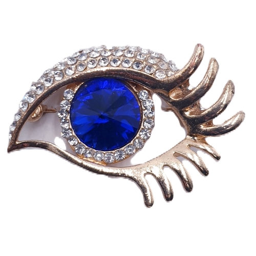 247 - WHITE METAL / BLUE STONE SET BROOCH FASHIONED AS AN EYE