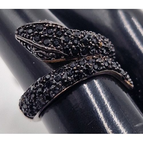 59 - WHITE METAL & BLACK STONE SET RING IN THE FORM OF A SNAKE (Size M-N ) (Boxed)