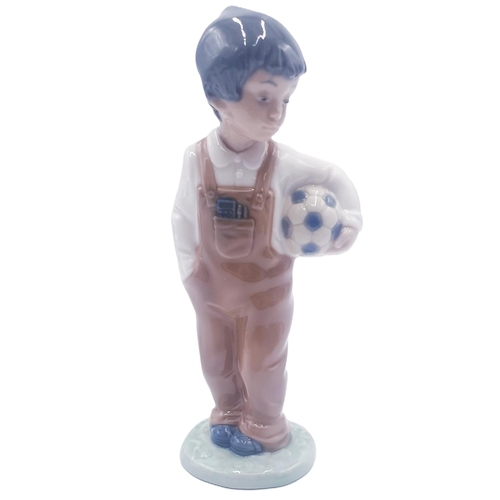 1 - LLADRO (Nao) 18.5cm PORCELAIN CHARACTER FIGURINE OF A YOUNG BOY HOLDING A FOOTBALL 