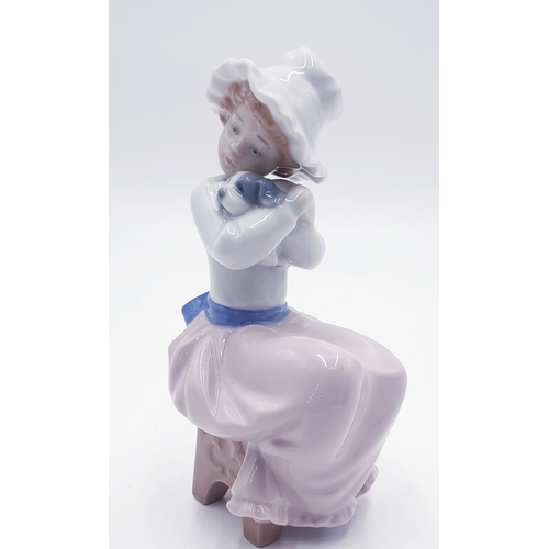 312 - LLADRO (Nao) PORCELAIN 16.5cm CHARACTER FIGURINE OF A YOUNG GIRL HOLDING A PUPPY