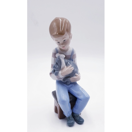 293 - LLADRO (Nao) PORCELAIN 17cm CHARACTER FIGURINE OF A YOUNG BOY HOLDING HIS POORLY PUPPY IN HIS ARMS 